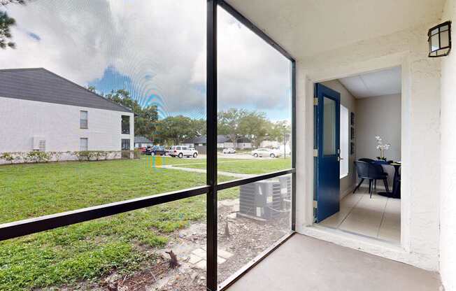 A patio with a table and chairs is visible through a glass door.