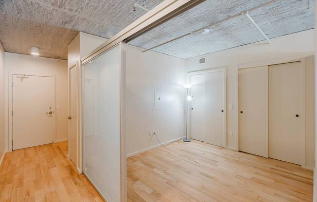 A room with wooden floors and white walls.