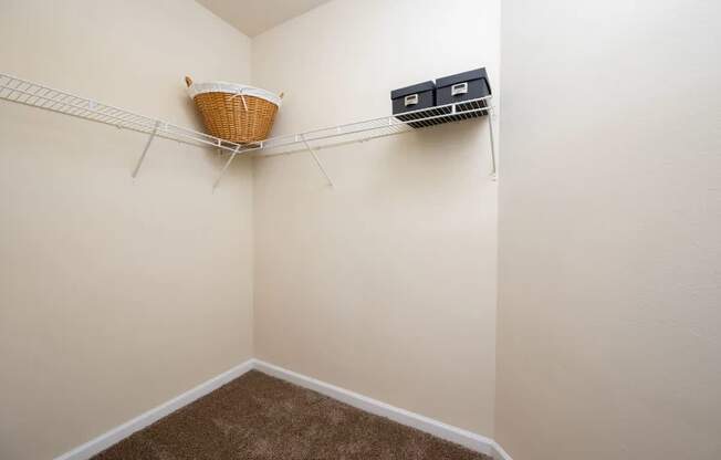 a closet with a basket hanging on the wall