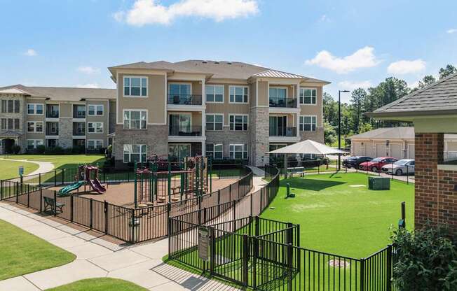 A large apartment complex with a playground in the front.