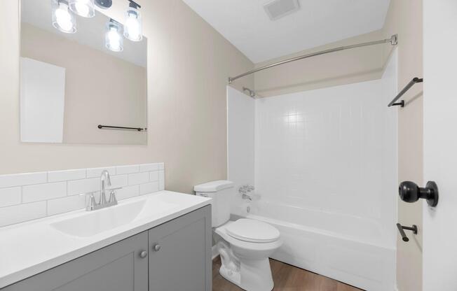 A white toilet sits next to a sink in a bathroom.