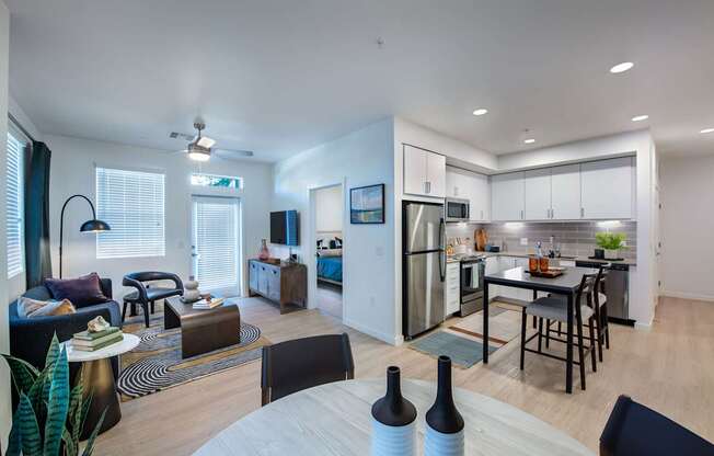 an open living room and kitchen with a table and chairs