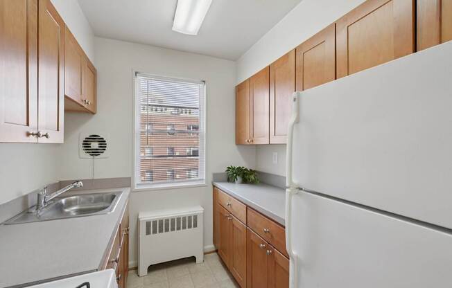 A kitchen with wooden cabinets and white appliances.