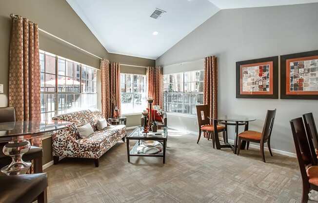 a living room and dining room with a table and chairs