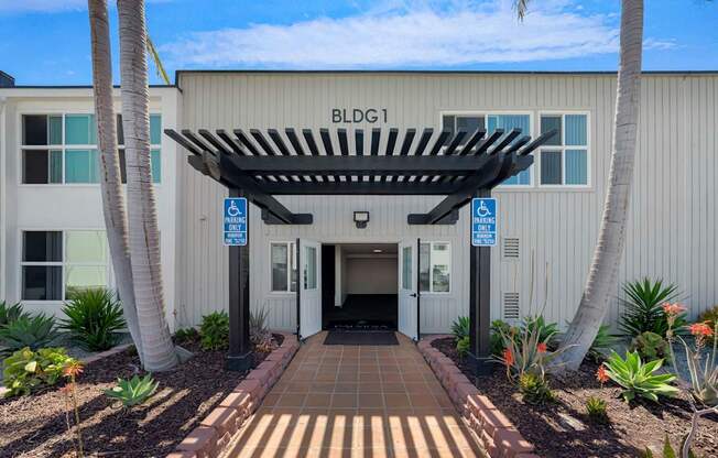 The image shows a building entrance with a sign that reads "BLDG1".