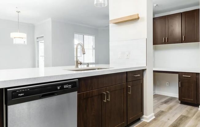 a kitchen with wooden cabinets and a sink and a window