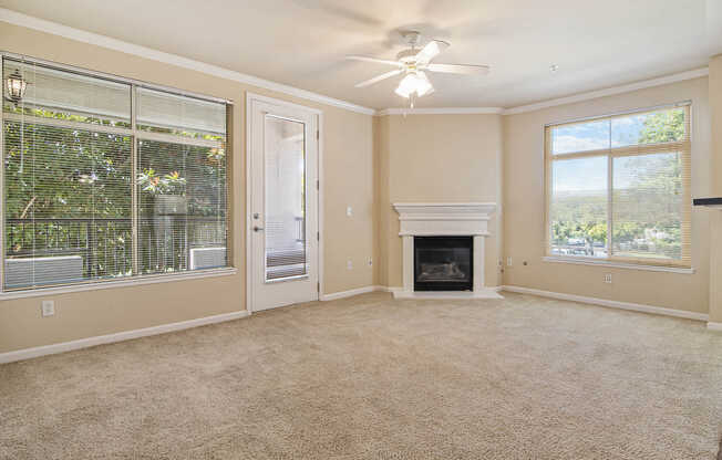 Carpeted Living Room  with Balcony and Fireplace