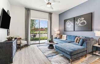 an open living room with a blue couch and a tv