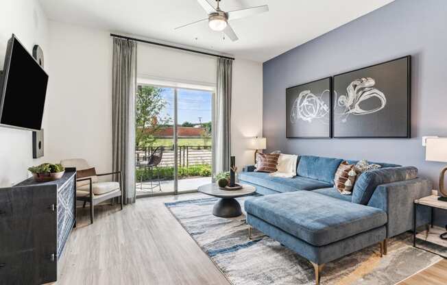 an open living room with a blue couch and a tv