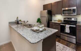 a kitchen with granite countertops and stainless steel appliances