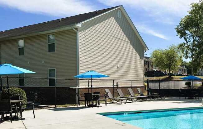 A pool area with a building in the background.