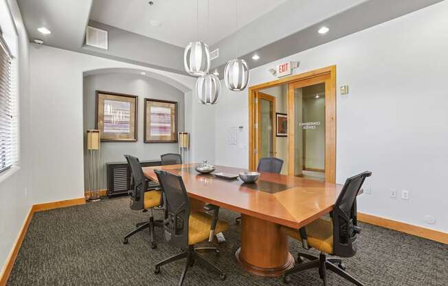 A conference room with a large table and chairs.