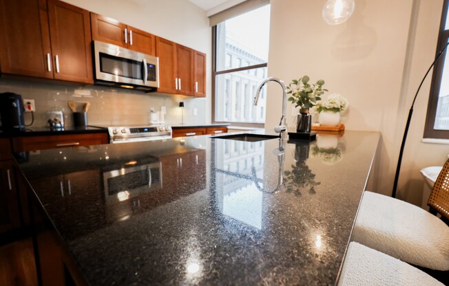 Kitchen with Granite Countertop and Modern Appliances at The Terminal Tower Residences Apartments, Ohio, 44113