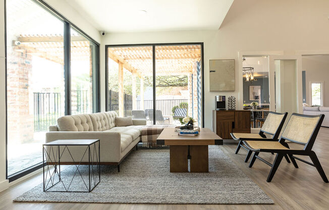 a living room with a white couch and a wooden coffee table in front of a sliding glass at Sunset Canyon, San Antonio, TX, 78232