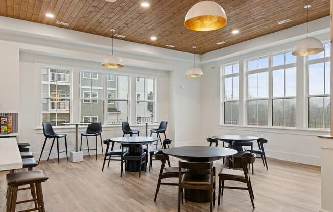 Dining room with tables and chairs and large windows at Hadley Place Apartments, Pennsylvania, 17025