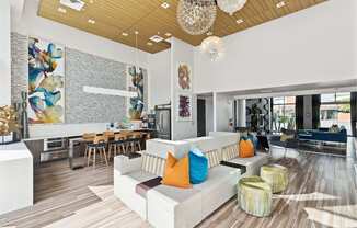 A modern living room with a white couch and a wooden floor.