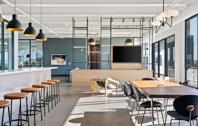 a large dining room with tables and chairs and a television
