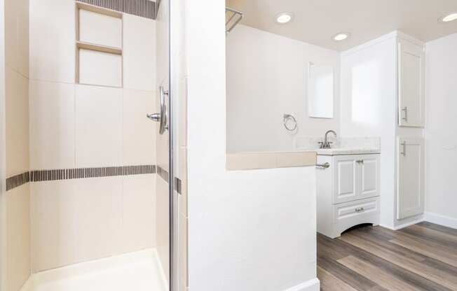 a bathroom with a shower and a sink