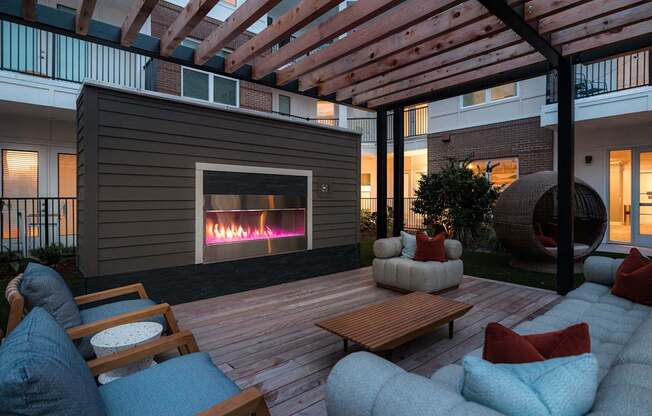 A patio with a fireplace and seating area.