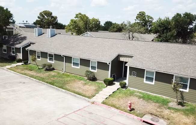 A parking lot in front of a building with a fire hydrant.