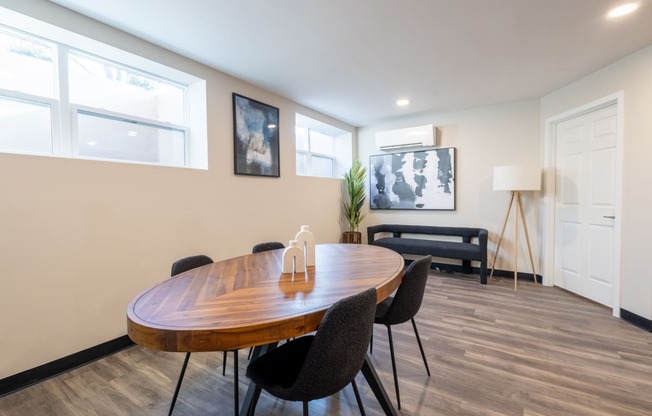 a dining room with a wooden table and chairs