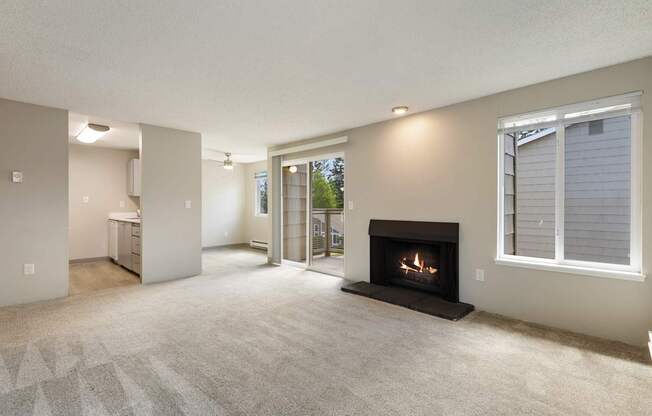 A living room with a fireplace and a carpet.