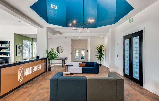 A Montgomery office lobby with a blue ceiling and a black door.