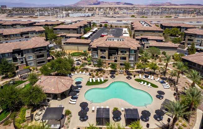an aerial view of a resort style community with an outdoor pool and hot tub
