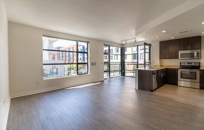 A spacious kitchen with dark wood cabinets and stainless steel appliances.