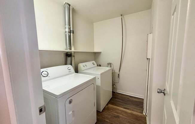 A small laundry room with a washer and dryer.