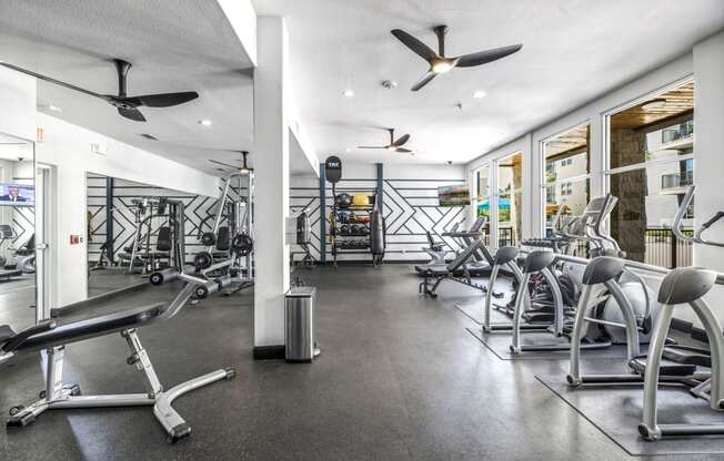 a workout room with a variety of exercise equipment