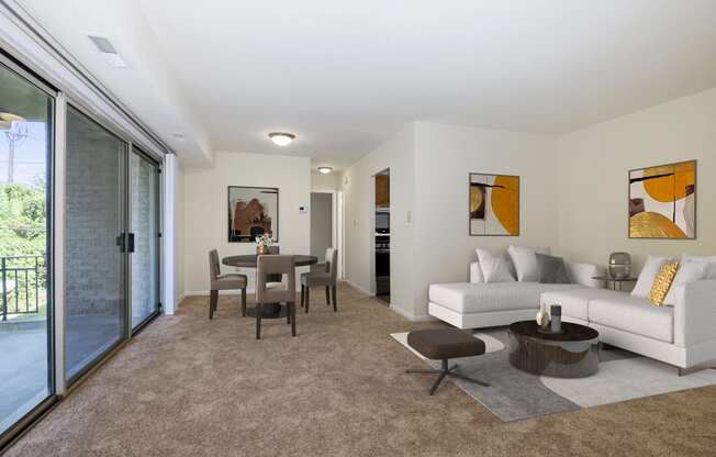 a living room with a white couch and a dining room table