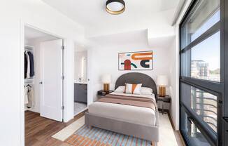 a bedroom with a large bed and a large window