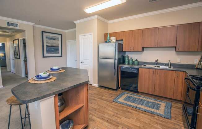 a kitchen with stainless steel appliances and wooden cabinets and a granite counter top