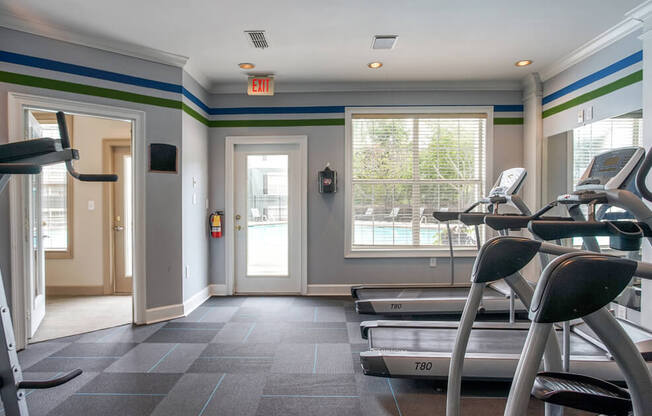 A gym with treadmills and exercise equipment.
