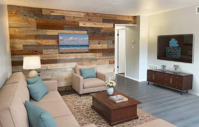 A living room with a couch, chair, and a coffee table.