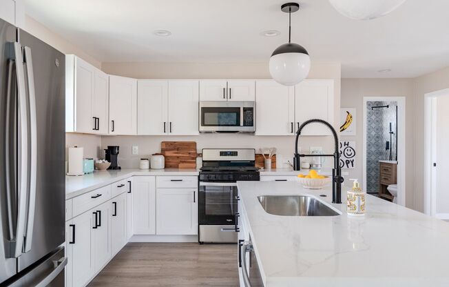Stunning 4 Bed / 2 Bath with Chef’s Kitchen, In-Unit Laundry and Shared Backyard Retreat