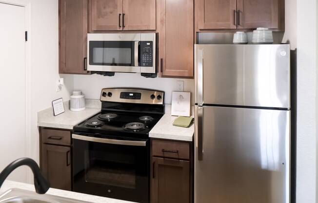 a kitchen with wooden cabinets and stainless steel appliances