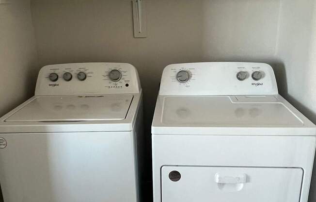 a pair of washers and dryers in a room