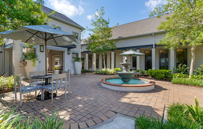 a patio with a fountain and a table and chairs at Summerwind, Pearland Texas