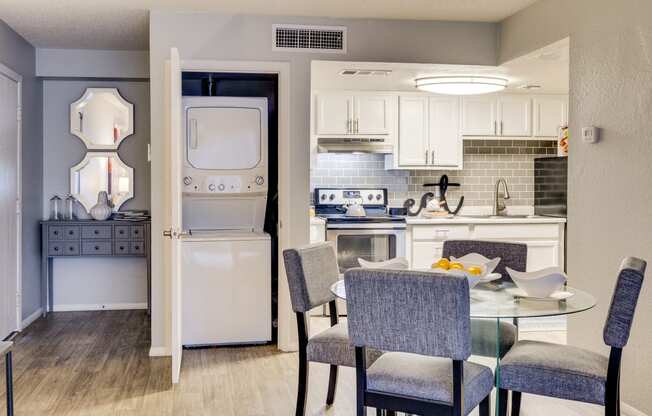 a kitchen and dining room with a table and chairs