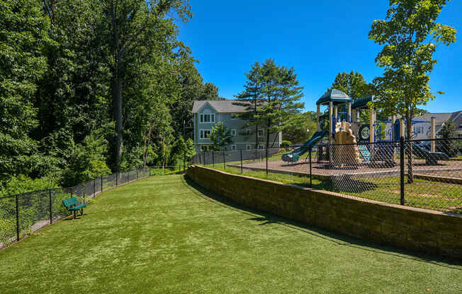 a yard with a playground and a swing set