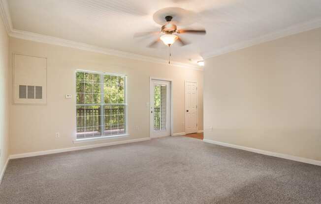 Cozy living room featuring carpeted flooring at Angel Landing apartments in Pensacola, FL