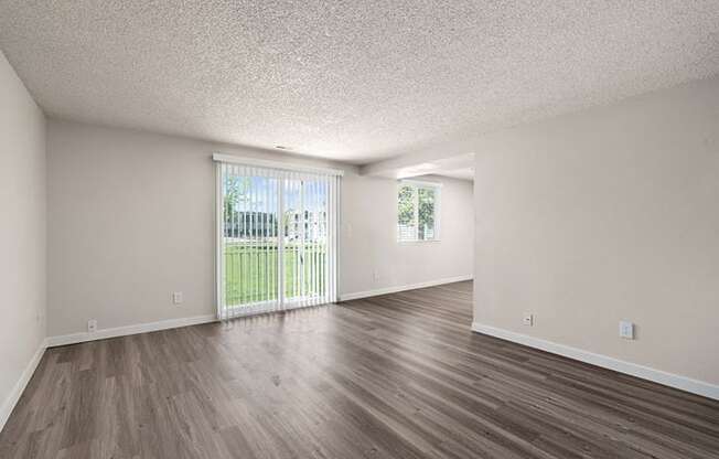 an empty living room with a sliding glass door