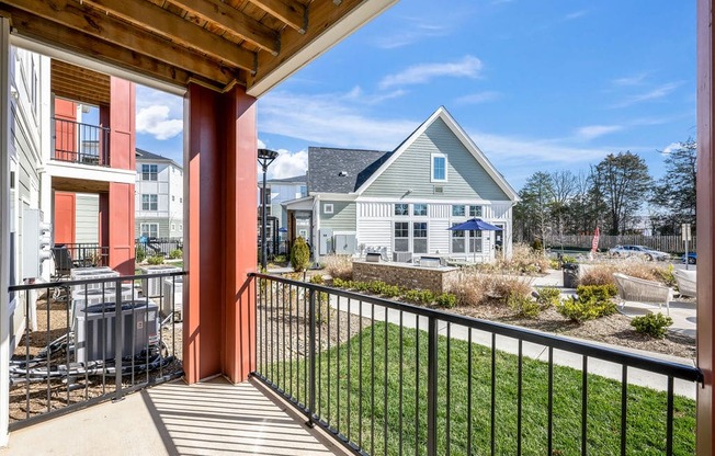 the view from the balcony of a home with a yard and a house