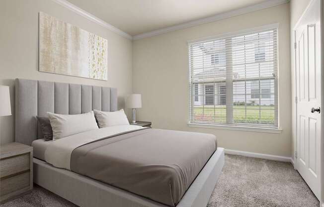 A bedroom with a large bed and a window with blinds.