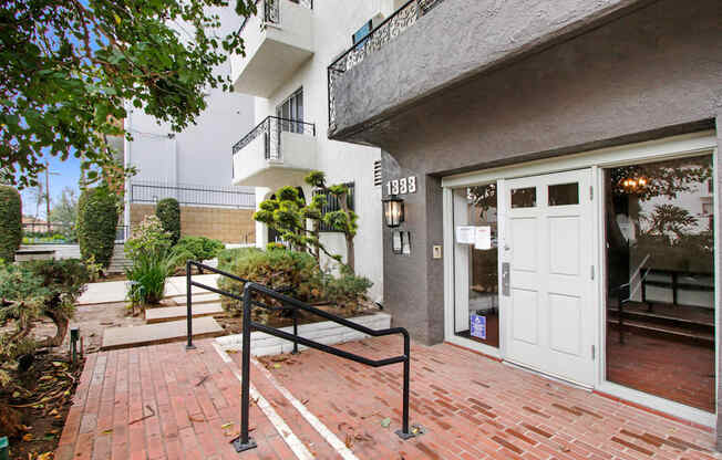 the entrance to a building with a staircase and a white door