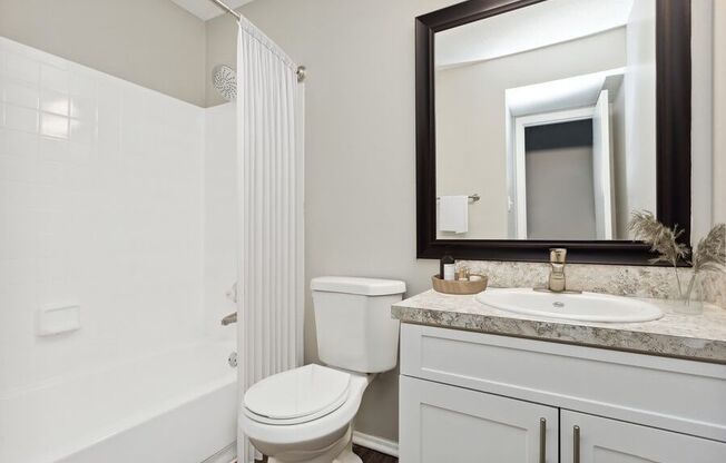 Model Bathroom with White Vanity at Caribbean Breeze Apartments in Tampa, FL.
