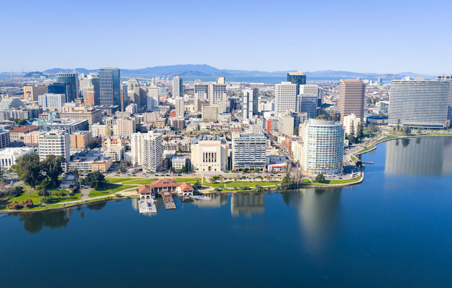 A cityscape with a large body of water in the foreground.