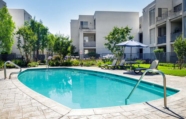 a swimming pool in front of an apartment building